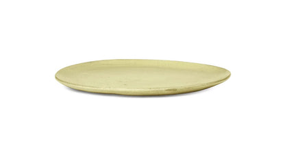 Discover the beauty of the FermLiving Flow Plate from ARCHIVE, a stunning artisanal kitchenware piece in a captivating yellowish greenish hue.